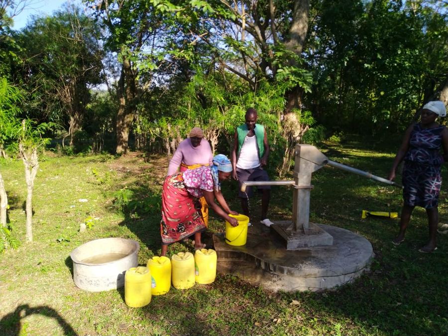 Community members collecting clean water from a GNEF-supported water point